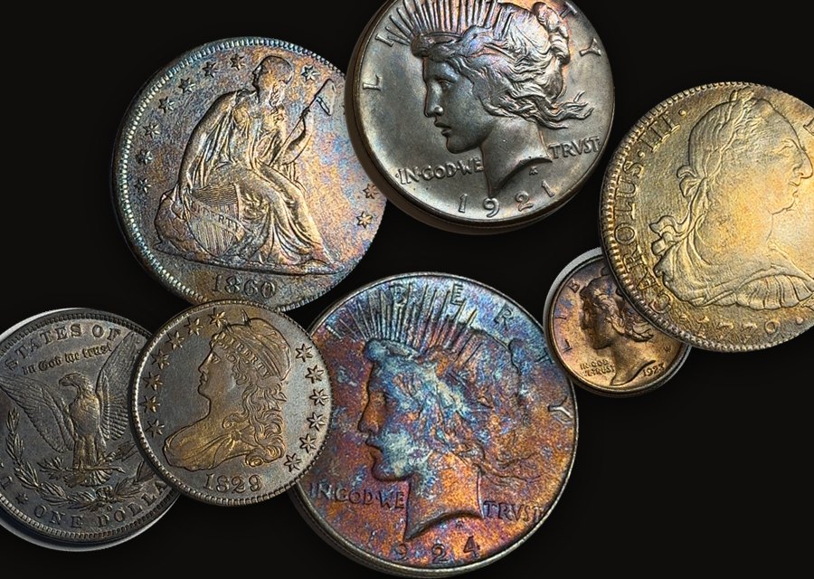 A handful of silver coins: Seated Liberty, Peace and Morgan dollars, a Bust half, a Mercury dime and an 8 reales